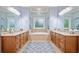 Bright bathroom featuring double vanities, granite countertops, and a luxurious soaking tub at 10731 Bossier Dr, Alpharetta, GA 30022