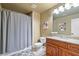 Bathroom with neutral walls, granite countertops, and tub shower with shower curtain at 10731 Bossier Dr, Alpharetta, GA 30022