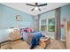 Sports-themed bedroom with a cozy bed, decorative accents, and a bright window view at 10731 Bossier Dr, Alpharetta, GA 30022