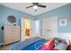 Bedroom with an adjacent bathroom and closet featuring cool blue walls and sports-themed decorations at 10731 Bossier Dr, Alpharetta, GA 30022