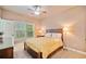 Cozy bedroom with a ceiling fan, a large window, and neutral colored walls at 10731 Bossier Dr, Alpharetta, GA 30022