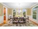 Traditional dining room featuring hardwood floors, neutral walls, and a stylish chandelier at 10731 Bossier Dr, Alpharetta, GA 30022