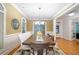 Dining room with hardwood floors, wainscoting, chandelier, and a view to the front entrance at 10731 Bossier Dr, Alpharetta, GA 30022