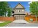 Exterior of a two-story home with a two car garage and privacy fence at 10731 Bossier Dr, Alpharetta, GA 30022