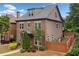 Exterior view of a two story home with a brick facade and a privacy fence at 10731 Bossier Dr, Alpharetta, GA 30022