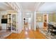 Elegant hallway with hardwood floors, crown molding, and decorative rugs at 10731 Bossier Dr, Alpharetta, GA 30022