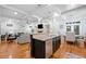 Open kitchen with an island, stainless steel appliances, and a view to the living room at 10731 Bossier Dr, Alpharetta, GA 30022