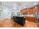 Spacious kitchen features an island, granite counters, and hardwood floors at 10731 Bossier Dr, Alpharetta, GA 30022