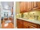 Kitchen featuring granite countertops, decorative backsplash, and views to dining area at 10731 Bossier Dr, Alpharetta, GA 30022