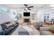 Living room featuring a stone fireplace, built-in shelving, and comfortable seating at 10731 Bossier Dr, Alpharetta, GA 30022
