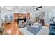 Open concept living space with hardwood floors, stylish furnishings, and view of kitchen at 10731 Bossier Dr, Alpharetta, GA 30022