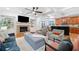 Open living room with coffered ceilings, hardwood floors, and views into the kitchen at 10731 Bossier Dr, Alpharetta, GA 30022