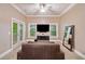 Cozy living room area features a television, outdoor balcony access, and a mirror at 10731 Bossier Dr, Alpharetta, GA 30022