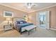 Comfortable primary bedroom showcasing neutral tones, ceiling fan, and ensuite access at 10731 Bossier Dr, Alpharetta, GA 30022