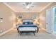 Bright main bedroom with a ceiling fan and views of the exterior at 10731 Bossier Dr, Alpharetta, GA 30022