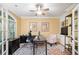 Bright office with French doors, built-in shelves, and a comfortable seating area at 10731 Bossier Dr, Alpharetta, GA 30022