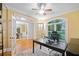 Well-lit office with French doors, a large desk, and hardwood flooring at 10731 Bossier Dr, Alpharetta, GA 30022