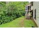 Home exterior with backyard, stone steps, and lush landscaping at 885 Falling Water Ln, Norcross, GA 30093