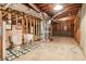 Unfinished basement features toilet, utility sink and exposed framework at 885 Falling Water Ln, Norcross, GA 30093