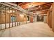 Unfinished basement with exposed framework, utilities, and concrete floor at 885 Falling Water Ln, Norcross, GA 30093