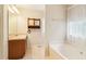 Bathroom features a large soaking tub, separate shower, vanity, and tiled floors for a spa-like experience at 885 Falling Water Ln, Norcross, GA 30093