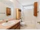 Bright bathroom with single sink, built-in cabinets, and tub/shower at 885 Falling Water Ln, Norcross, GA 30093