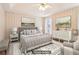 A virtually staged bedroom showcases neutral tones, a comfortable bed, and coordinated furnishings at 885 Falling Water Ln, Norcross, GA 30093