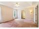 Bedroom with wallpapered walls, carpeted flooring, and a view into the ensuite bathroom at 885 Falling Water Ln, Norcross, GA 30093