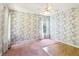 Bedroom showcasing carpet, wallpaper, and a window with curtains at 885 Falling Water Ln, Norcross, GA 30093