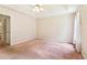 Bedroom featuring wallpapered walls, carpeted flooring, and a view into the hallway and closet at 885 Falling Water Ln, Norcross, GA 30093