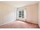Bright bedroom featuring wallpapered walls, carpeted flooring, and natural light from a large window at 885 Falling Water Ln, Norcross, GA 30093