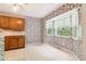 Cozy dining area with windows providing natural light, adjacent to the kitchen at 885 Falling Water Ln, Norcross, GA 30093
