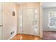Bright foyer with wood floors, sidelight windows, and a white front door at 885 Falling Water Ln, Norcross, GA 30093