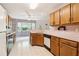 Bright kitchen with essential appliances, wooden cabinets, and natural light from a nearby window at 885 Falling Water Ln, Norcross, GA 30093