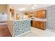 Well-lit kitchen with wooden cabinets and appliances, open to the dining area at 885 Falling Water Ln, Norcross, GA 30093