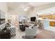 Staged living room showcases an open floor plan, seamlessly connecting to the dining area and kitchen at 885 Falling Water Ln, Norcross, GA 30093