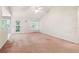 Spacious living room features natural light, a vaulted ceiling, and access to the backyard at 885 Falling Water Ln, Norcross, GA 30093
