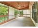 Screened porch featuring a wood ceiling, ceiling fan, and views of greenery at 885 Falling Water Ln, Norcross, GA 30093