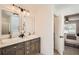 Bright bathroom featuring double sinks, granite counters and a decorative furniture-style vanity at 3290 Spincaster Way, Loganville, GA 30052