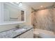 Modern bathroom featuring a granite countertop, marble backsplash, and tub-shower combo at 3290 Spincaster Way, Loganville, GA 30052