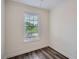 Cozy bedroom featuring a window with blinds and rich dark hardwood floors at 3290 Spincaster Way, Loganville, GA 30052