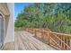 Spacious deck with wood flooring overlooks a large, lush, wooded backyard at 3290 Spincaster Way, Loganville, GA 30052