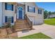 Home featuring a cozy front entrance, stone details, and an attached two-car garage at 3290 Spincaster Way, Loganville, GA 30052