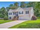 Traditional home with a two-car garage, front lawn, and blue shutters under a bright sky at 3290 Spincaster Way, Loganville, GA 30052