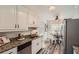 Bright kitchen with stainless steel appliances, stone counters and a breakfast nook at 3290 Spincaster Way, Loganville, GA 30052