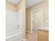 Bathroom showcases a white shower-tub combination and a glimpse into the walk-in closet at 4230 Pilgrim Point Rd, Cumming, GA 30041