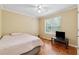Light-filled bedroom with wood floors and a large window, offering a calming and peaceful retreat at 4230 Pilgrim Point Rd, Cumming, GA 30041