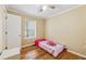 Comfortable bedroom with hardwood floors and a window providing natural light, ideal for rest and relaxation at 4230 Pilgrim Point Rd, Cumming, GA 30041