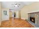 Inviting living room with a stone fireplace and hardwood floors, perfect for cozy evenings at 4230 Pilgrim Point Rd, Cumming, GA 30041