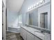 Bathroom with a double granite vanity, modern lighting, a bathtub, and a standing shower at 5380 Rock Place Drive, Stone Mountain, GA 30087